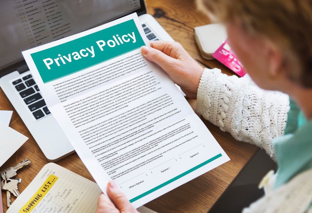 A woman holding up a privacy policy agreement.